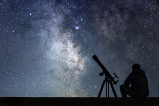 Sternenhimmel und Mann mit Teleskop